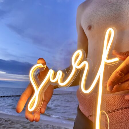Neonowy napis z napisem surf. Surfing, plaża, fale